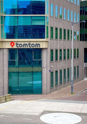 Amsterdam, Netherlands-June 2, 2023-  The logo on the side of a  local office building for TomTom a manufacturer of automotive navigation systems