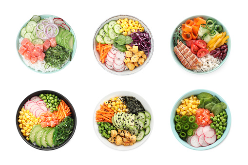 Set of different poke bowls isolated on white, top view