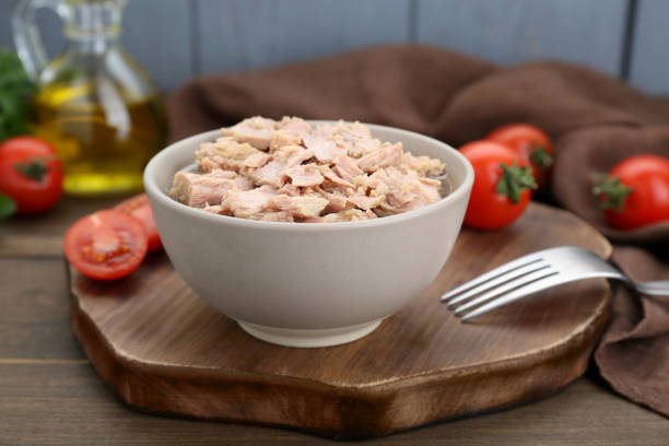 istock Bowl with canned tuna on wooden table 1498785440