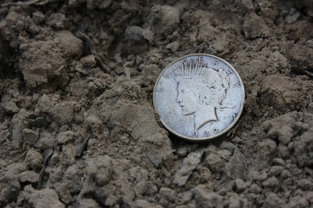 istock 1922 Silver Peace Dollar On Ground in Dirt. Front View 1498787428