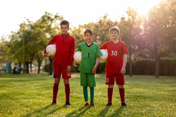 istock soccer players outside holding balls 1498793183