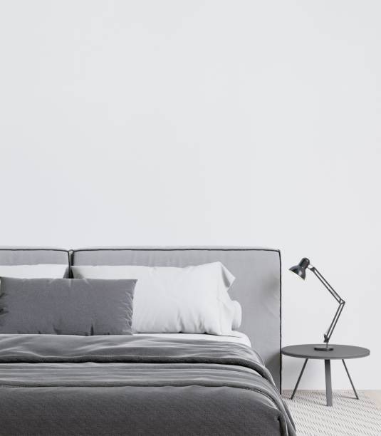 istock Contemporary bedroom with a soft grey bed, and table lamp. 3d rendering. 1498793409