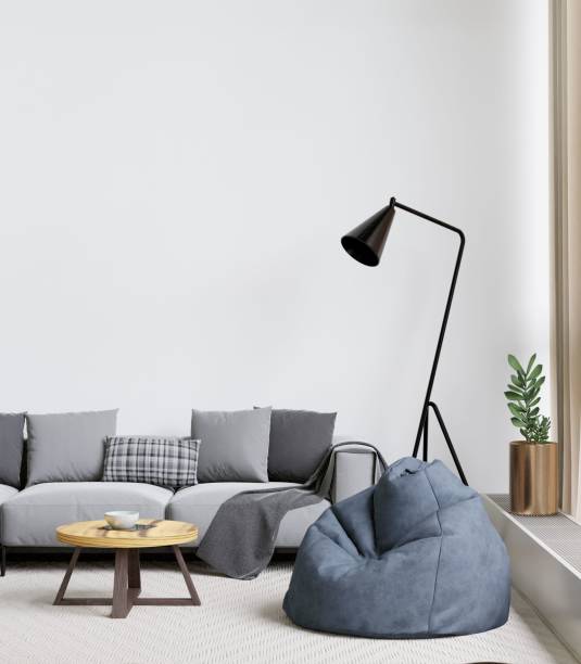 istock Contemporary living room with a grey sofa, coffee table, lamp, and a bean bag. 3d rendering. 1498793422