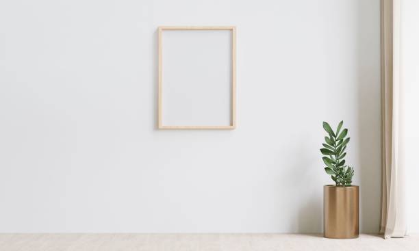 istock Empty wooden frame hangs on a white wall in a luminous room. 3d rendering. 1498793425
