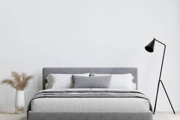 istock Contemporary bedroom with a soft grey bed, and lamp. 3d rendering. 1498793529