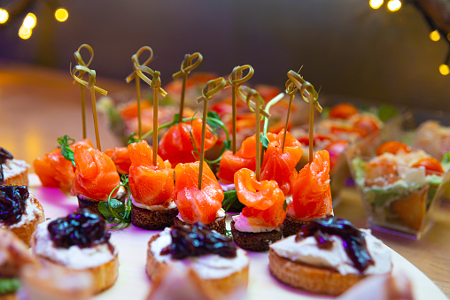 Canapes with salmon, microgreens and cream cheese spread on rye bread