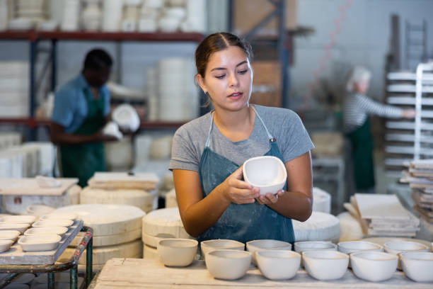 istock Young woman potter with new crafted ceramic bowls 1498796137