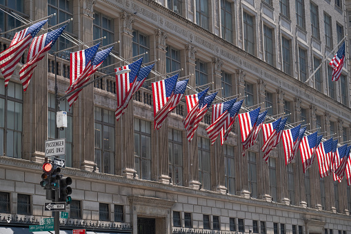United States or America Flags  on the facade of a building in midtown New York City.