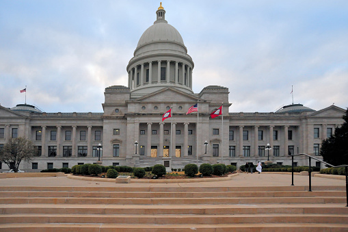 Little Rock, Arkansas, USA: Arkansas State Capitol - home of the Arkansas General Assembly, and the seat of the Arkansas state government - architect George R. Mann and  Cass Gilbert - Classical Revival limestone façade, the stone was quarried in Batesville, Arkansas - neo-classical portico with bronze doors - Woodlane Street / Capitol Mall, Capitol Hill.