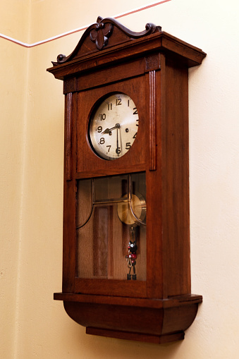 Antique wall clock on white background