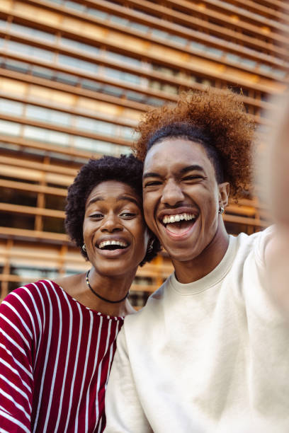 Young people taking a selfie on the street. Point of view Shot of cheerful African American young people in urban part of the city. They are taking selfie and smiling man video call pov stock pictures, royalty-free photos & images