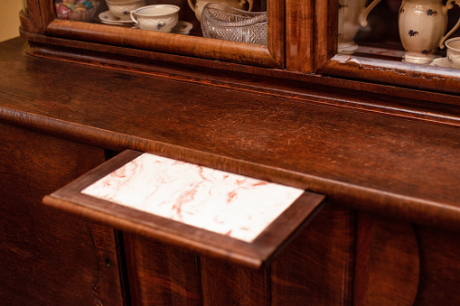 Antique piece of furniture wooden chest of drawers close-up.