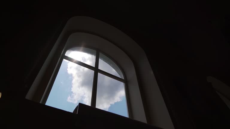 A ray of light through the window in an abandoned temple. Dust cloud