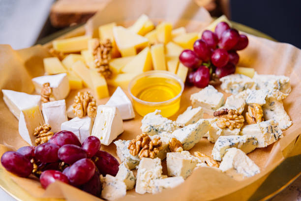 istock Cheese platter with different types of cheese, grapes, walnuts and honey 1498805389