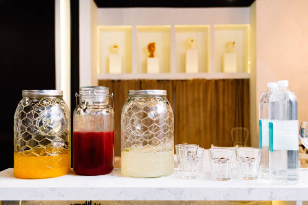 istock Transparent glass jars with drinks: juice, compote, morsel on the bar counter. 1498805439