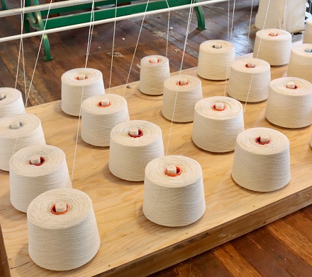Close-up of the thread feeds in a woolen mill