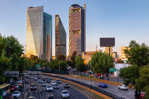 Skyscrapers in Mexico City’s financial district with afternoon traffic in the foreground