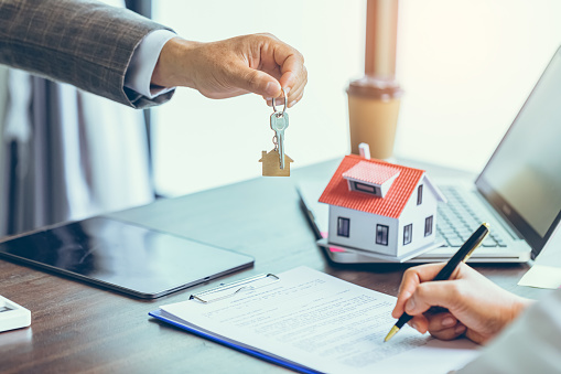 Real estate agent or real estate agent was holding the key to the new landlord,tenant or rental.After the banker has approved and signed the purchase agreement successfully.Property concept.