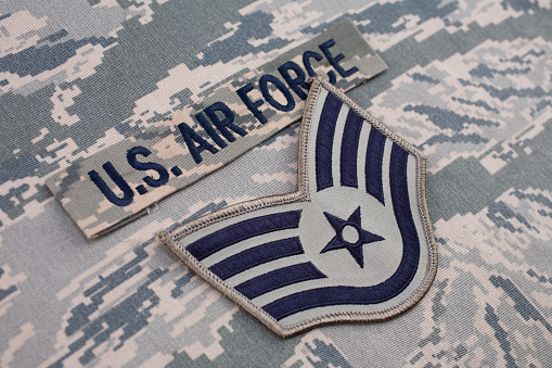 AIR FORCE branch tape and Staff Sergeant rank patch on digital tiger-stripe pattern Airman Battle Uniform background