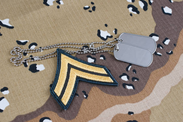 istock US ARMY Corporal rank patch and dog tags on desert camouflage uniform 1498812817