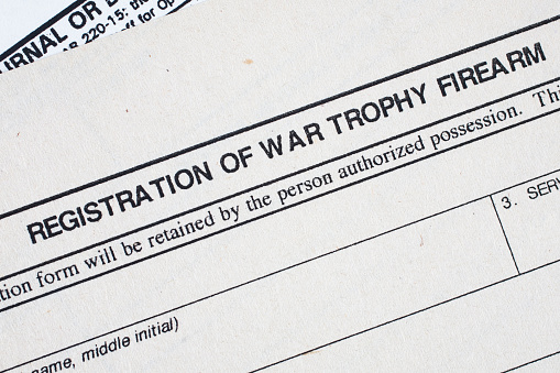 Registration of war trophy firearm form. US Army old paper background.