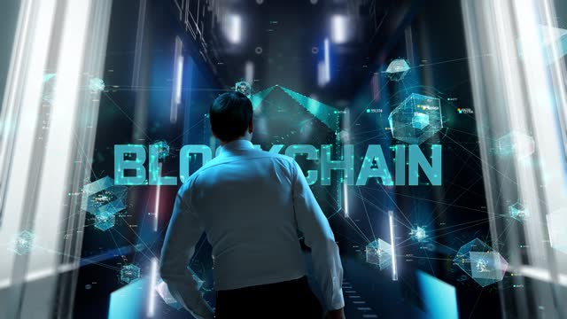Blockchain. Man in Futuristic Office Interior Moving and Activating Hologram.