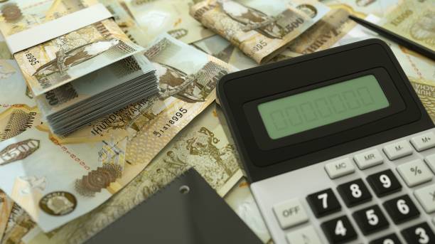 istock Zambian Kwacha notes spread out with a calculator, pen and notebook. 3d rendering 1498817360