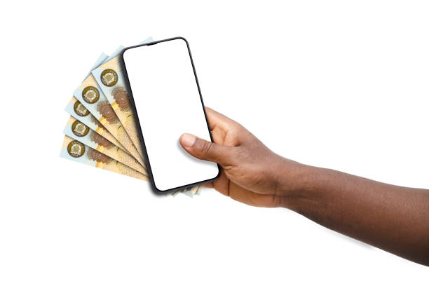 istock Black hand holding mobile phone with blank screen and Zambian Kwacha notes 1498817390