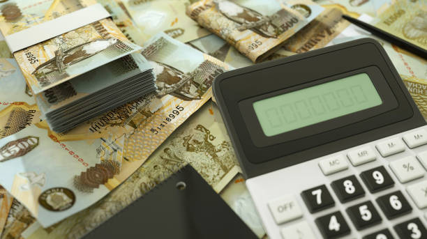 istock Zambian Kwacha notes spread out with a calculator, pen and notebook. 3d rendering 1498819271