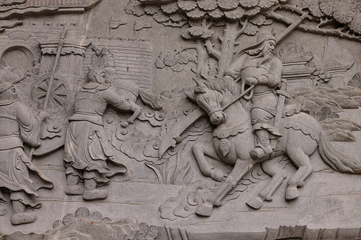 Stone depiction of war scene at Nghia An Hoi Quan Pagoda - Guan Di Temple in Ho Chi Minh City, Vietnam
