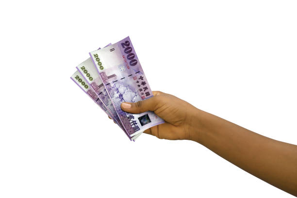 istock Fair hand holding 3D rendered 2000 New Taiwanese dollar notes isolated on white background 1498823019