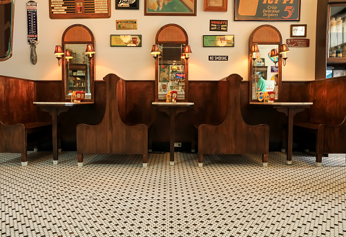 The interior of an historic restaurant building with the original flooring and the original wooden booths