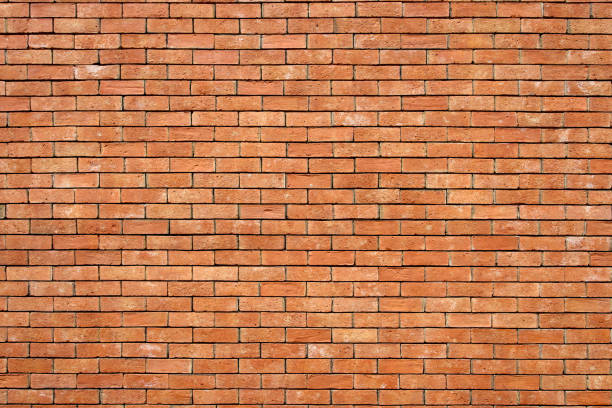 istock Orange polygonal brick wall background texture, retro style brick design 1498830330