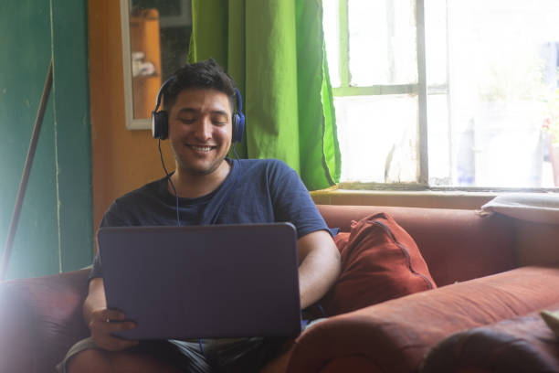 istock Mexican young man working from home has a meeting with a work team where they have a great time. 1498830806