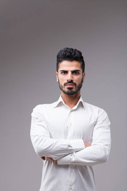 istock Serious man in white, arms crossed 1498834403