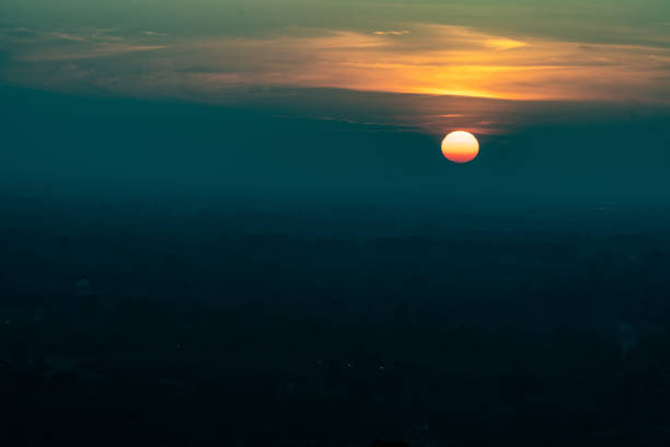 Sunset or sunrise over the tropical mountains silhouette. Scattered clouds on the sky background with space for using in banner of natural concept, nature landscape scene
