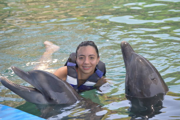 istock Smiling with a Dolphin in the Aquarium 1498837252