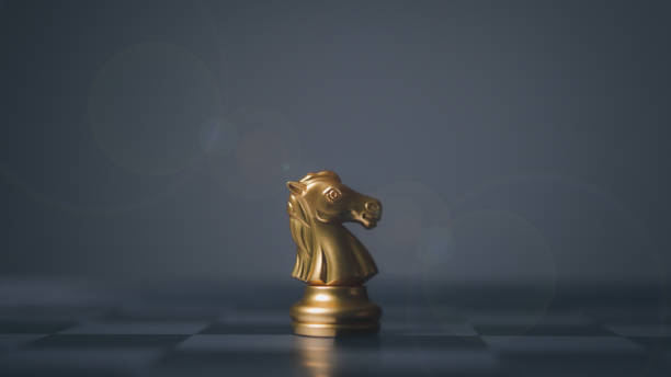 istock Golden horse chess encounters. Chess board game, business competitive. 1498837343