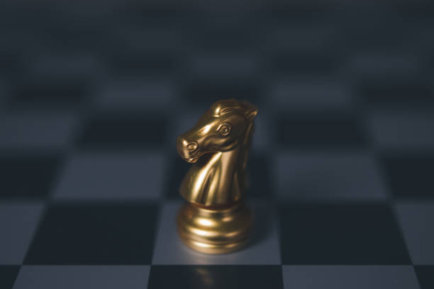 istock Golden horse chess encounters. Chess board game, business competitive. 1498837345