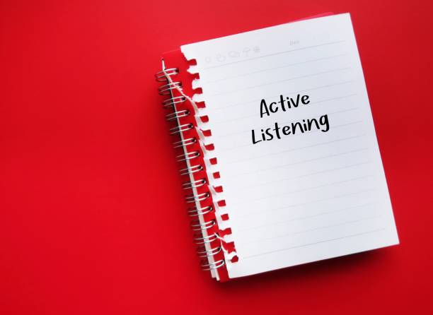 istock Notebook on red copy space background with handwritten text Active listening - skill of listen attentively to speaker, understand and respond or reflect on what's being said with fully engagement 1498839780