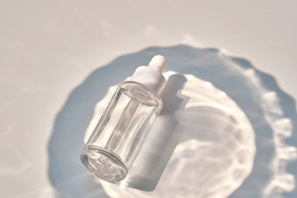 istock Serum bottle on a blue background with glare. 1498841380