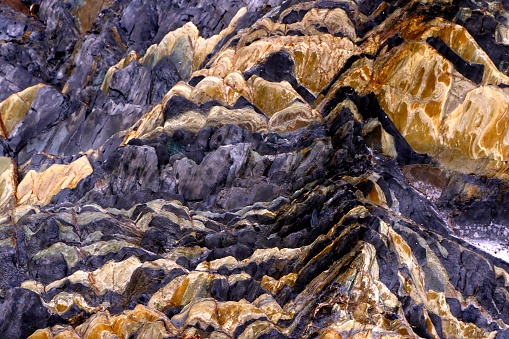 Colorful rock striations in the cliff face at Second Valley on the Fleurieu Peninsula, South Australia
