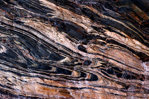 Colorful rock striations in the cliff face at Second Valley on the Fleurieu Peninsula, South Australia