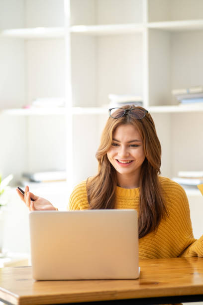 istock Distance Education. E-learning, Study online, Smiling beautiful woman sitting at desk and wearing headphone head set study online class zoom google meet discord, Happy engaged girl attending for learn 1498848295