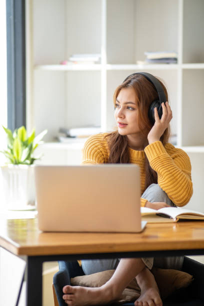 istock Distance Education. E-learning, Study online, Smiling beautiful woman sitting at desk and wearing headphone head set study online class zoom google meet discord, Happy engaged girl attending for learn 1498848349