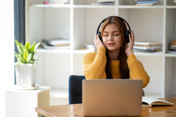 istock Distance Education. E-learning, Study online, Smiling beautiful woman sitting at desk and wearing headphone head set study online class zoom google meet discord, Happy engaged girl attending for learn 1498848382