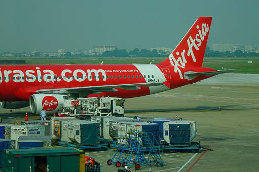 Singapore - Feb 8, 2018. An AirAsia aircraft docking at Changi Airport of Singapore. Changi serves more than 100 airlines, with connections to 380 cities in 90 countries.