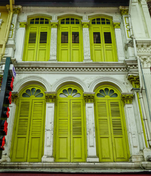 Yellow wooden windows of an ancient building in Chinatown, Singapore.