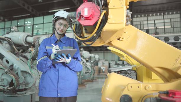 istock Mechanical engineer check the quantity of the machine parts and confirm workpiece on tablet in robot manufacturing plant. Female technician wearing safety uniform working in robotic arm production line, inspection the quality to meet the standards. 1498860179