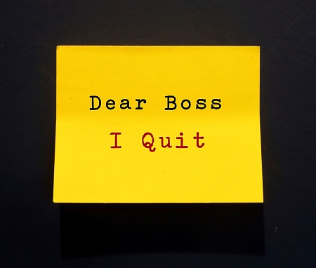 Yellow stick note on black background with handwritten DEAR BOSS I QUIT, refers to decision making of employees to quit job, to leave workplace, to resign from full time employment